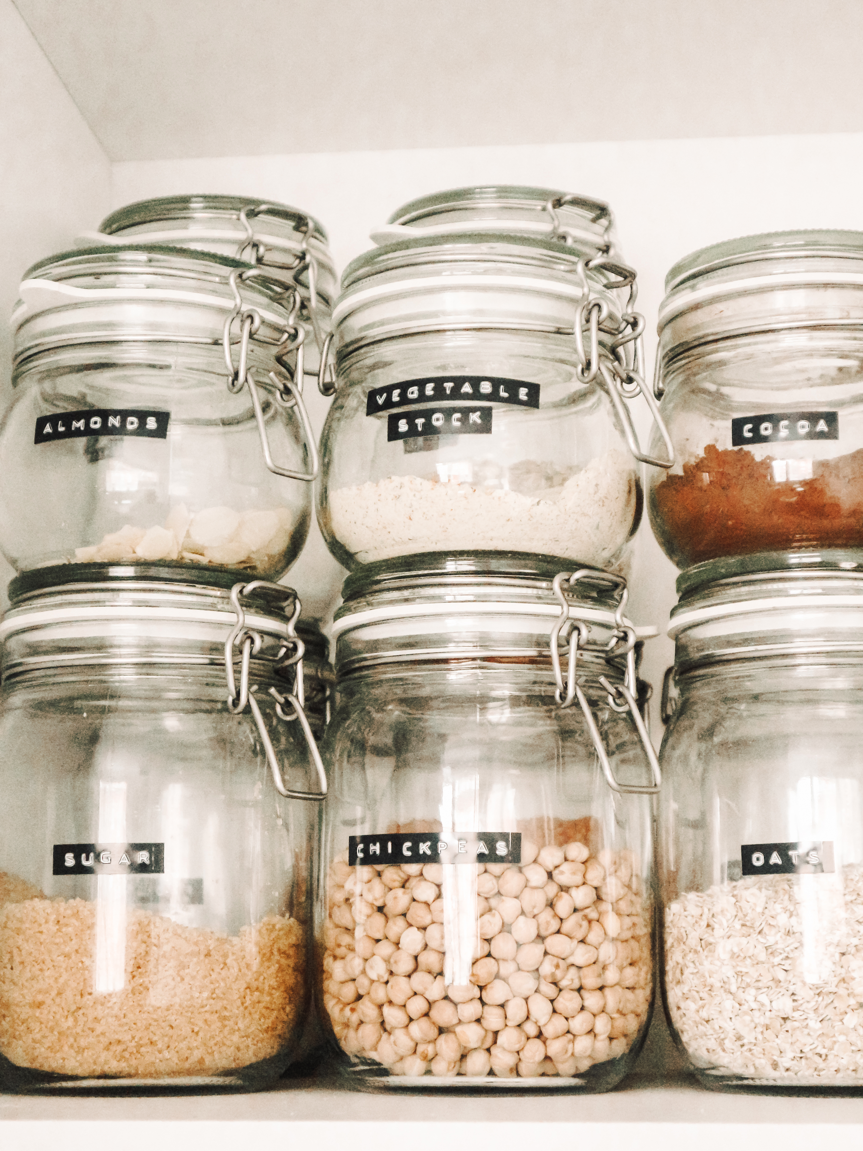 Clear food containers with legumes, oats, sugar.